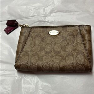 Coach Brown Clutch with Monogram Pattern and Zipper Closure